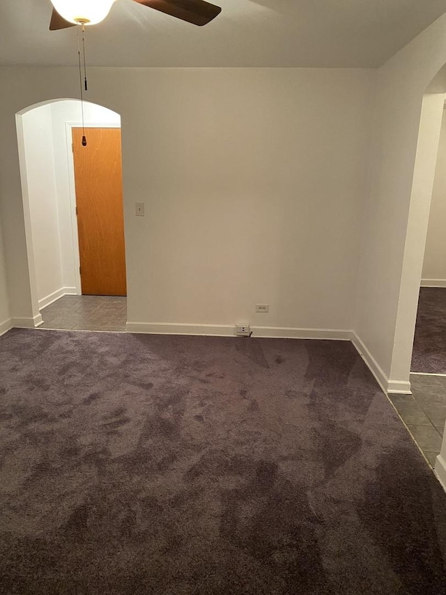 808 Bellwood Ave Unit 1N, Bellwood, IL 60104 - empty room featuring arched walkways, a ceiling fan, dark carpet, and baseboards