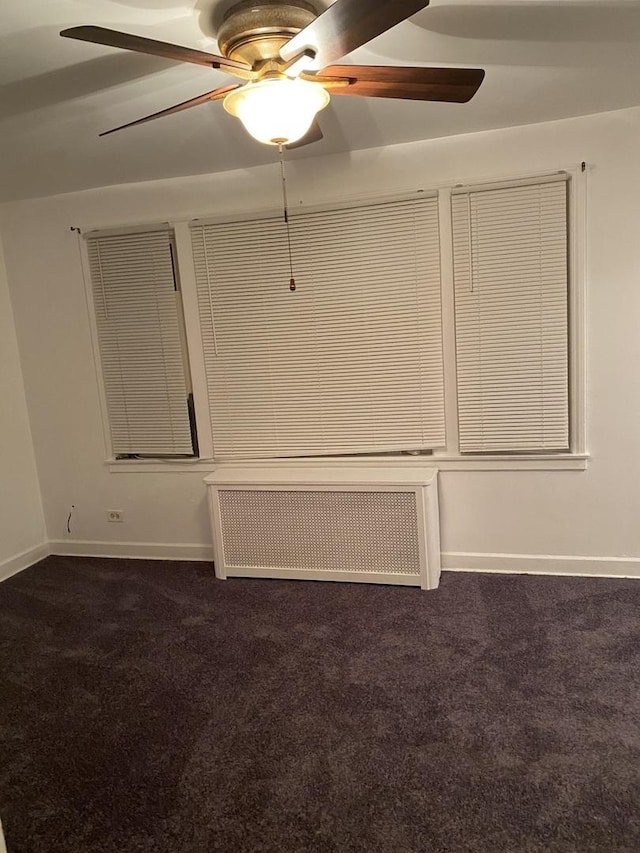 808 Bellwood Ave Unit 1N, Bellwood, IL 60104 - empty room featuring radiator, dark colored carpet, ceiling fan, and baseboards