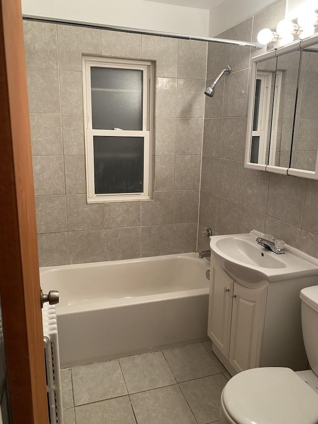 808 Bellwood Ave Unit 1N, Bellwood, IL 60104 - bathroom with toilet, tile patterned floors, tile walls, vanity, and shower / tub combination