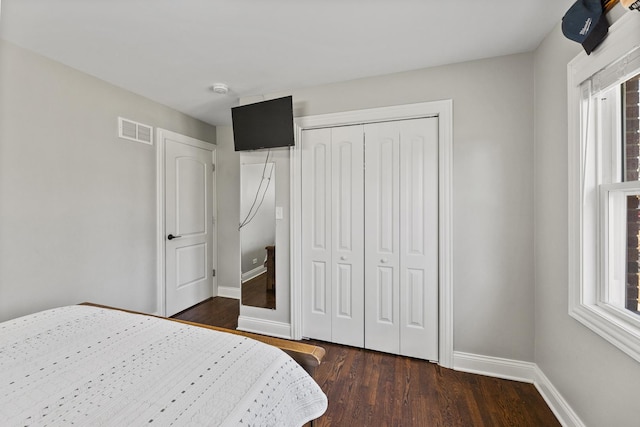 8320 Latrobe Ave, Burbank, IL 60459 - bedroom featuring dark wood finished floors, baseboards, multiple windows, and a closet
