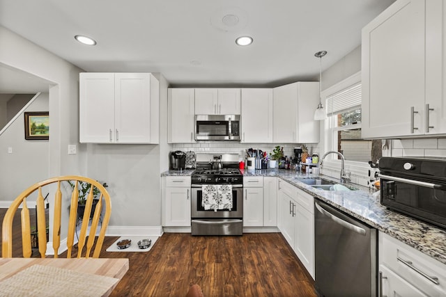 8320 Latrobe Ave, Burbank, IL 60459 - kitchen featuring appliances with stainless steel finishes, a sink, dark wood finished floors, white cabinets, and light stone countertops