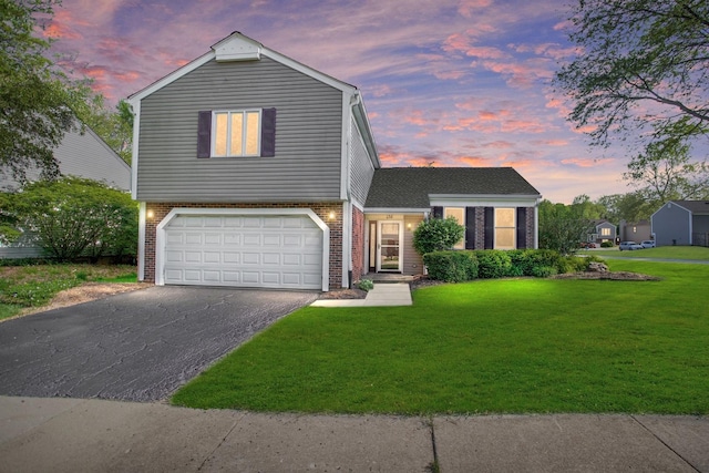 view of front of home featuring driveway, brick siding, a garage, and a front lawn