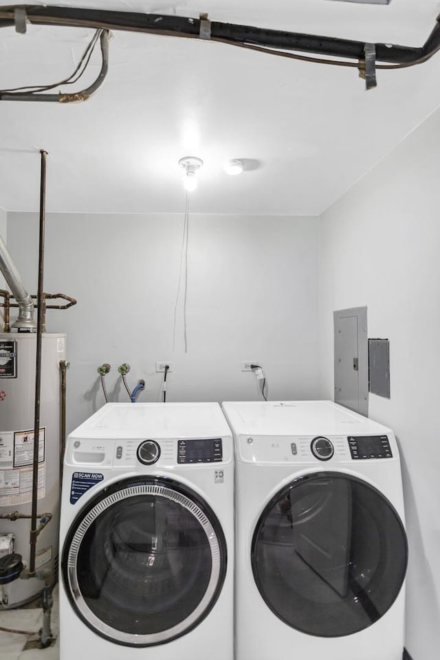 laundry area with water heater, electric panel, and washing machine and dryer