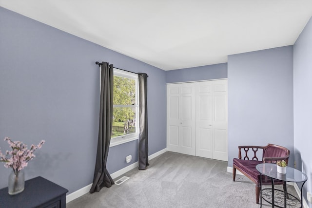 sitting room with light colored carpet and baseboards