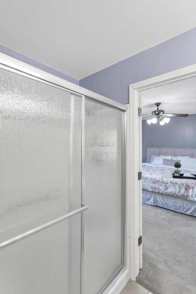 full bathroom featuring ensuite bath, a stall shower, and a ceiling fan