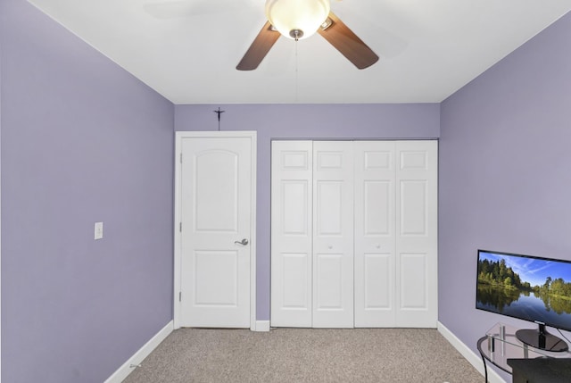 unfurnished bedroom with carpet, baseboards, and a closet