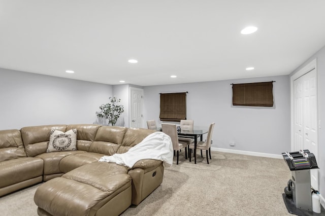 living area featuring recessed lighting, light carpet, and baseboards