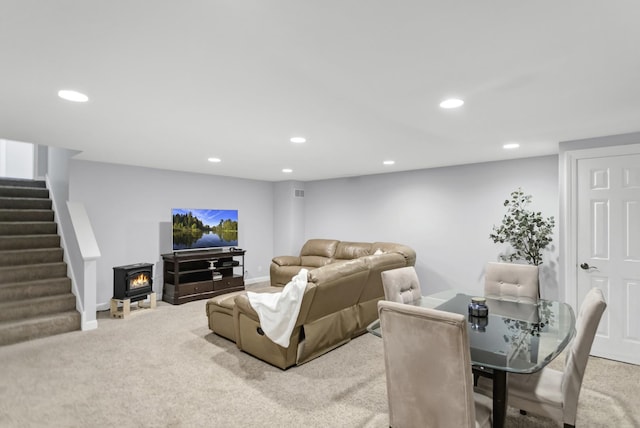 living area featuring light carpet, recessed lighting, stairs, and baseboards