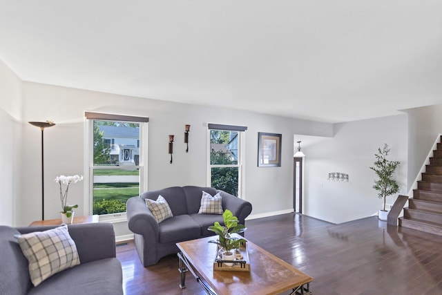 living area with stairs, wood finished floors, and baseboards