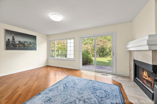 105 Concord Ln, Carol Stream, IL 60188 - unfurnished living room featuring a glass covered fireplace, wood finished floors, and baseboards