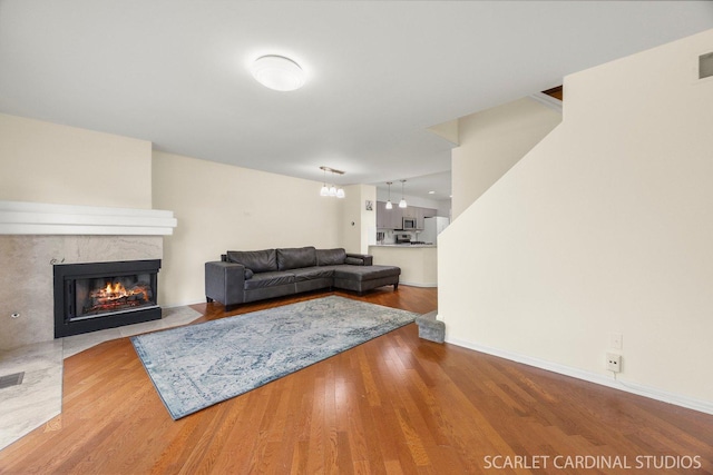 105 Concord Ln, Carol Stream, IL 60188 - living area featuring a fireplace with flush hearth, wood finished floors, and baseboards