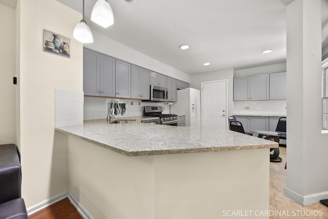 105 Concord Ln, Carol Stream, IL 60188 - kitchen featuring appliances with stainless steel finishes, gray cabinets, a peninsula, a sink, and decorative backsplash