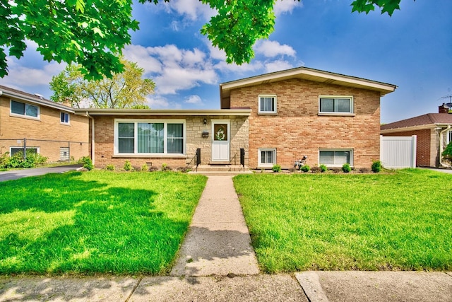 7906 Churchill St, Morton Grove, IL 60053 - split level home with a front yard and brick siding