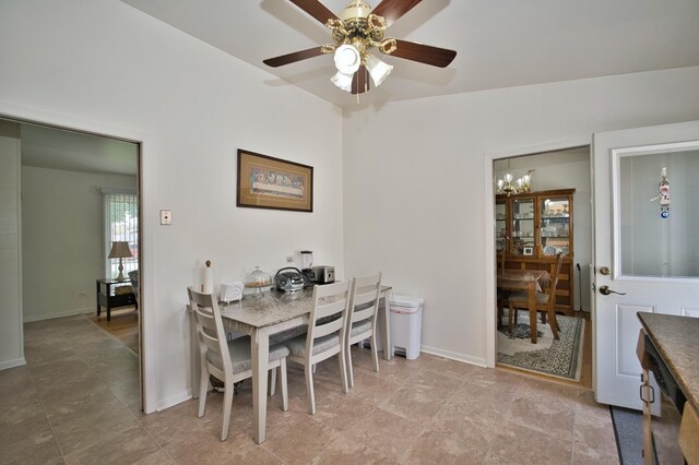 7906 Churchill St, Morton Grove, IL 60053 - dining room with a chandelier, baseboards, and ceiling fan