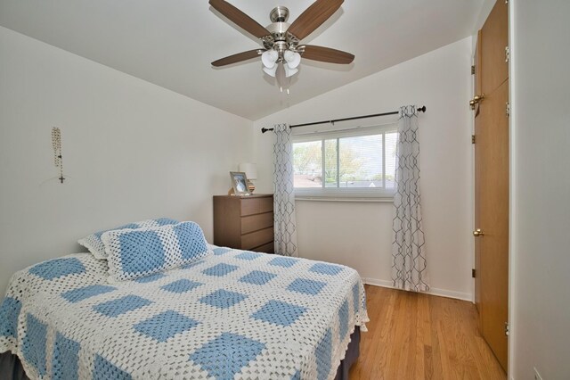 7906 Churchill St, Morton Grove, IL 60053 - bedroom featuring wood finished floors, vaulted ceiling, baseboards, and a ceiling fan