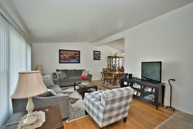 7906 Churchill St, Morton Grove, IL 60053 - living room with vaulted ceiling, light wood-style floors, and a chandelier