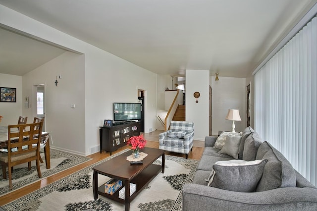 7906 Churchill St, Morton Grove, IL 60053 - living area with light wood-style flooring, baseboards, stairs, and lofted ceiling