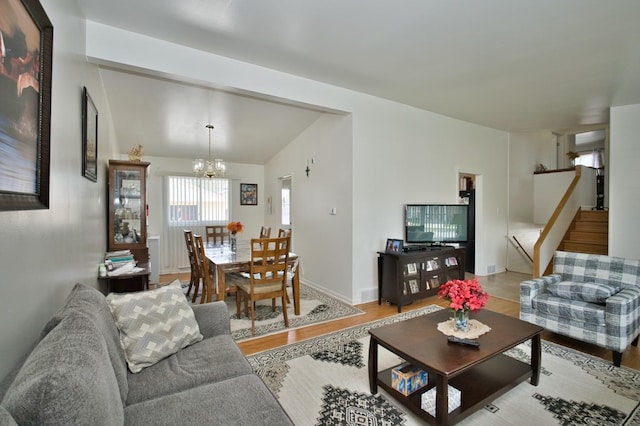 7906 Churchill St, Morton Grove, IL 60053 - living area with stairway, a chandelier, light wood-style floors, and lofted ceiling