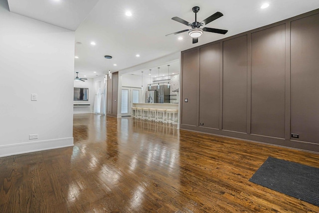 939 N Massasoit Ave, Chicago, IL 60651 - unfurnished living room with ceiling fan, a decorative wall, wood finished floors, recessed lighting, and baseboards