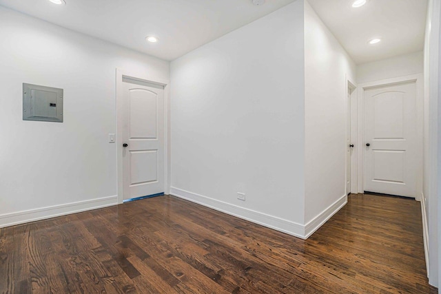 939 N Massasoit Ave, Chicago, IL 60651 - unfurnished room featuring electric panel, dark wood finished floors, baseboards, and recessed lighting