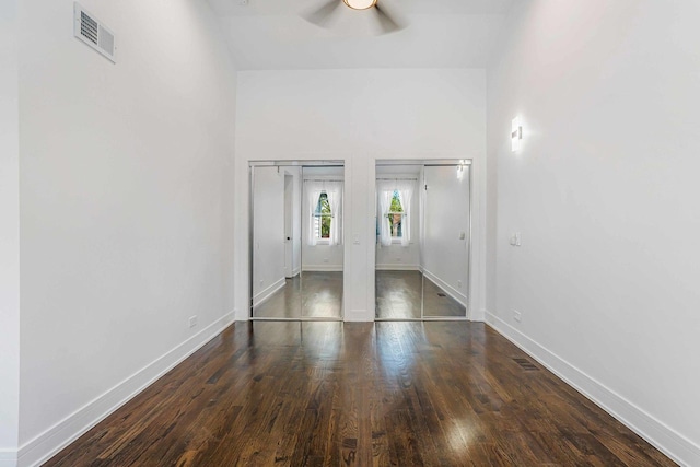 939 N Massasoit Ave, Chicago, IL 60651 - unfurnished bedroom with baseboards, wood finished floors, two closets, and ceiling fan
