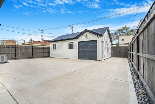 939 N Massasoit Ave, Chicago, IL 60651 - detached garage featuring cooling unit and concrete driveway