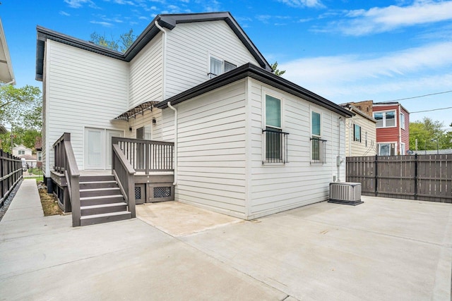 939 N Massasoit Ave, Chicago, IL 60651 - back of house featuring a patio, a deck, a fenced backyard, and central AC