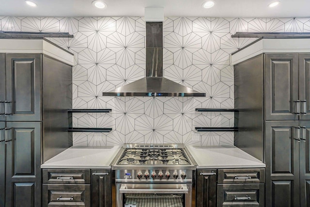 939 N Massasoit Ave, Chicago, IL 60651 - kitchen with wall chimney range hood, backsplash, stainless steel stove, and recessed lighting