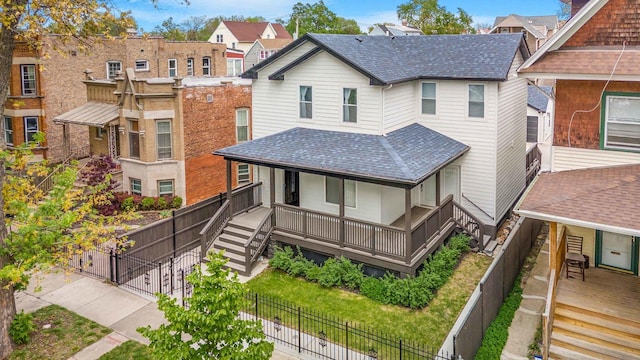939 N Massasoit Ave, Chicago, IL 60651 - view of front of house with covered porch, roof with shingles, stairway, and a residential view