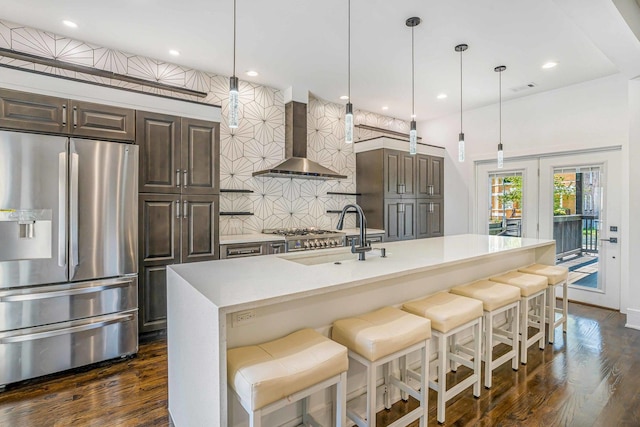 939 N Massasoit Ave, Chicago, IL 60651 - kitchen featuring stainless steel fridge with ice dispenser, wall chimney range hood, a sink, backsplash, and light countertops