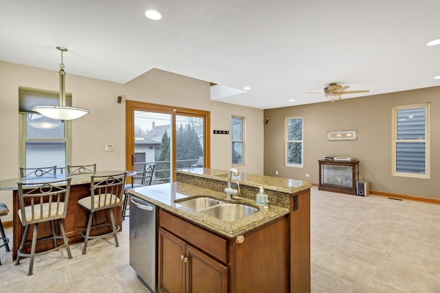 5301 S Mobile Ave, Chicago, IL 60638 - kitchen featuring a sink, dishwasher, brown cabinetry, ceiling fan, and a kitchen island with sink