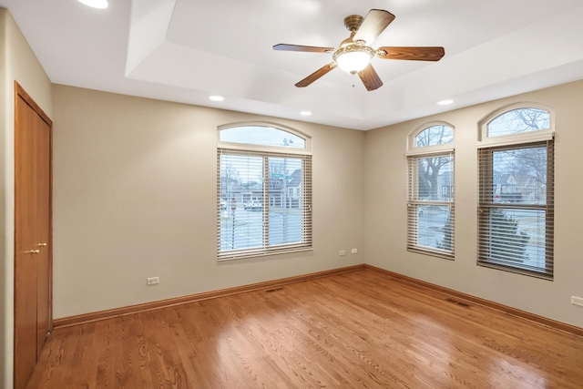 5301 S Mobile Ave, Chicago, IL 60638 - empty room with recessed lighting, light wood-style flooring, baseboards, a raised ceiling, and ceiling fan