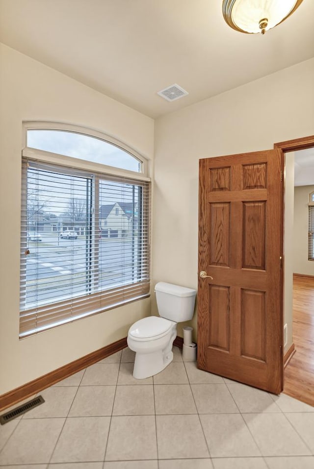 5301 S Mobile Ave, Chicago, IL 60638 - bathroom with toilet, tile patterned floors, and baseboards