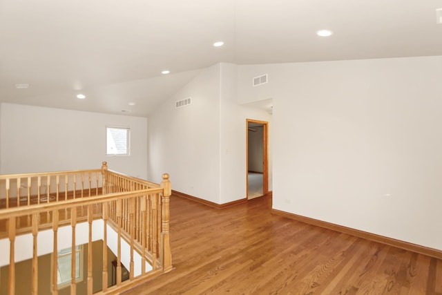 5301 S Mobile Ave, Chicago, IL 60638 - empty room with vaulted ceiling, baseboards, wood finished floors, and recessed lighting