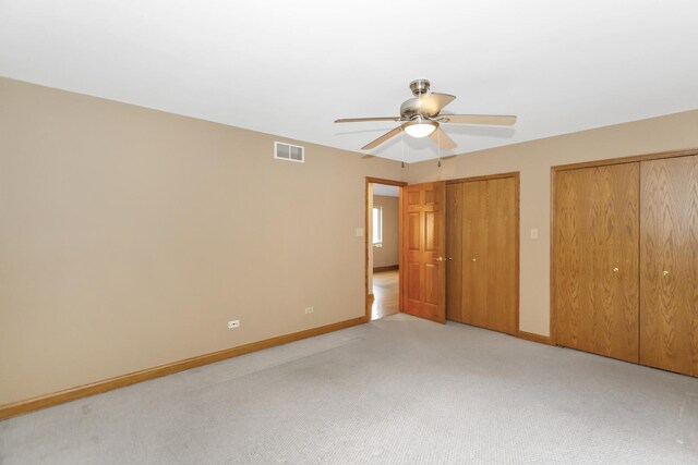 5301 S Mobile Ave, Chicago, IL 60638 - unfurnished bedroom with two closets, light carpet, baseboards, and ceiling fan
