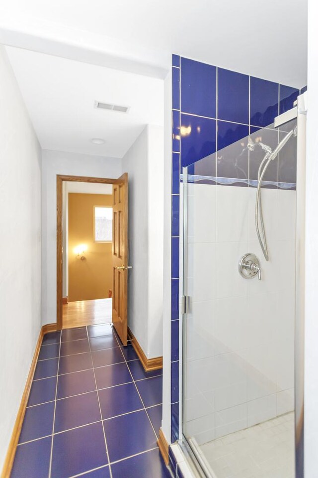 5301 S Mobile Ave, Chicago, IL 60638 - bathroom featuring baseboards, a stall shower, and tile patterned floors