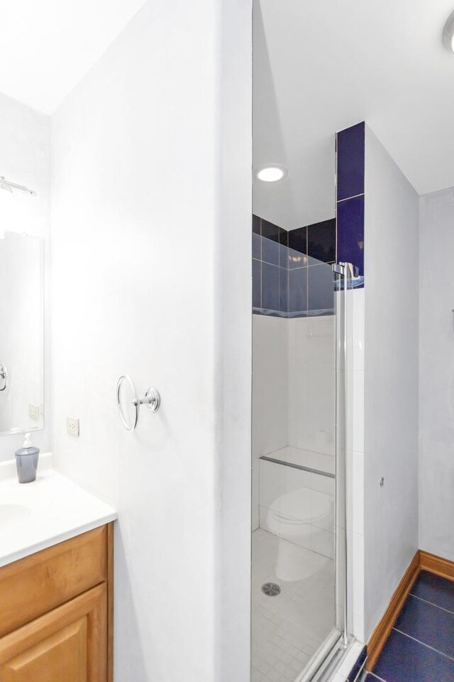 5301 S Mobile Ave, Chicago, IL 60638 - bathroom with a walk in shower, tile patterned floors, vanity, and toilet