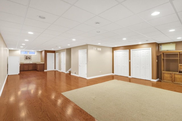 5301 S Mobile Ave, Chicago, IL 60638 - unfurnished living room featuring wood finished floors, baseboards, and a drop ceiling