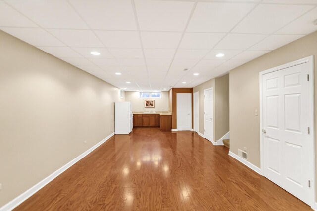 5301 S Mobile Ave, Chicago, IL 60638 - empty room with dark wood finished floors, a paneled ceiling, recessed lighting, and baseboards