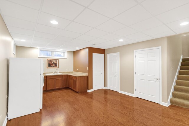 5301 S Mobile Ave, Chicago, IL 60638 - bar area featuring freestanding refrigerator, wood finished floors, a drop ceiling, stairs, and a sink