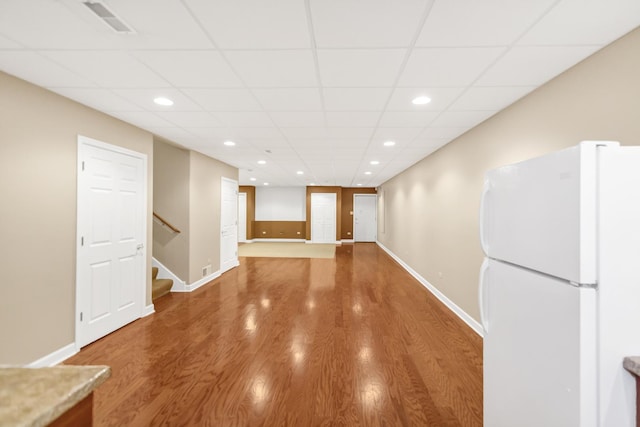 5301 S Mobile Ave, Chicago, IL 60638 - spare room with a drop ceiling, recessed lighting, baseboards, wood finished floors, and stairs
