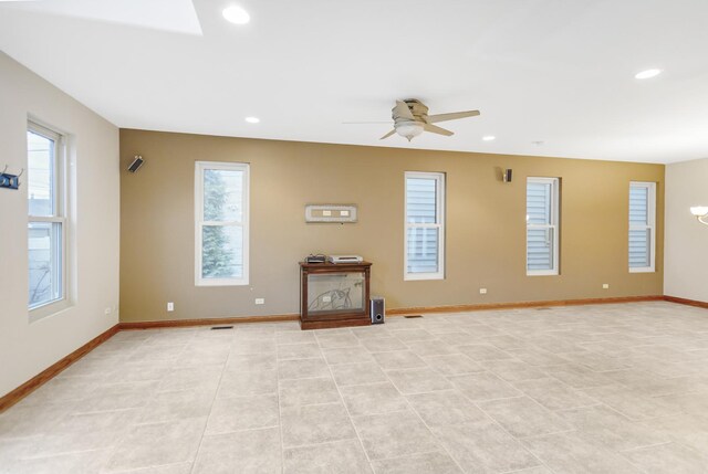 5301 S Mobile Ave, Chicago, IL 60638 - unfurnished living room featuring healthy amount of natural light, a ceiling fan, baseboards, and recessed lighting