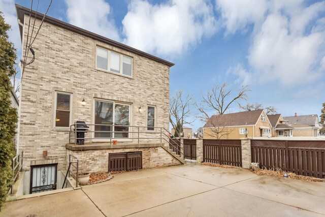 5301 S Mobile Ave, Chicago, IL 60638 - back of house featuring brick siding, fence, and a patio