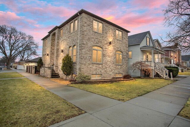 5301 S Mobile Ave, Chicago, IL 60638 - view of home's exterior featuring stairway, a lawn, brick siding, and a garage