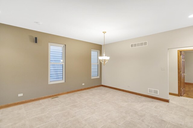 5301 S Mobile Ave, Chicago, IL 60638 - spare room featuring a chandelier and baseboards
