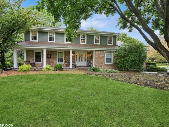 25 Lagoon Dr, Hawthorn Woods, IL 60047 - view of front facade with a front yard, brick siding, and a porch
