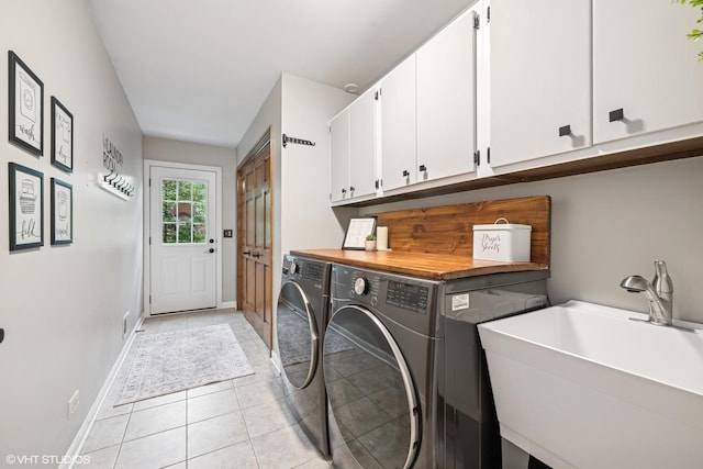 25 Lagoon Dr, Hawthorn Woods, IL 60047 - washroom with cabinet space, washer and clothes dryer, light tile patterned floors, and baseboards