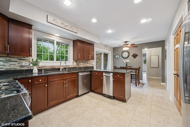 25 Lagoon Dr, Hawthorn Woods, IL 60047 - kitchen featuring appliances with stainless steel finishes, a sink, decorative backsplash, a peninsula, and ceiling fan