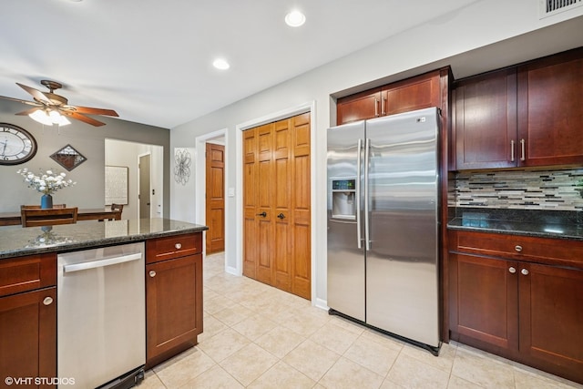 25 Lagoon Dr, Hawthorn Woods, IL 60047 - kitchen with stainless steel appliances, ceiling fan, tasteful backsplash, light tile patterned floors, and dark stone counters