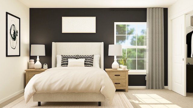 bedroom featuring light carpet and baseboards